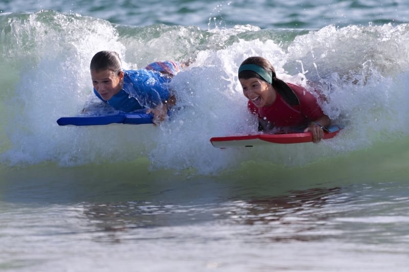 Kids in the surf New Quay Wales