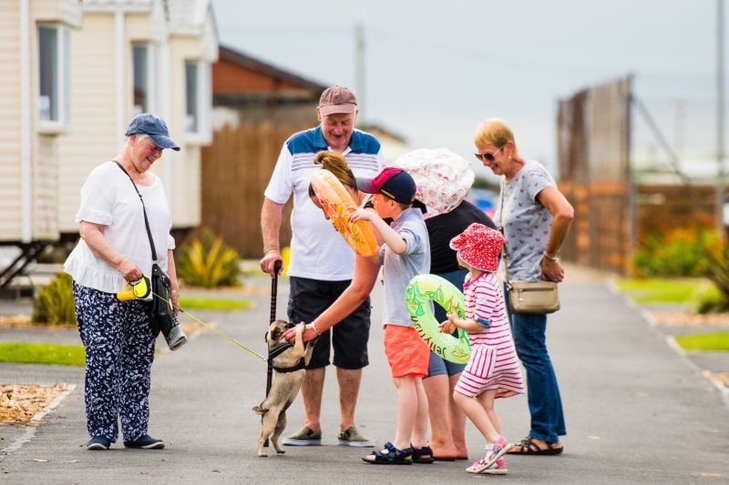 Family with dogs at a caravan site